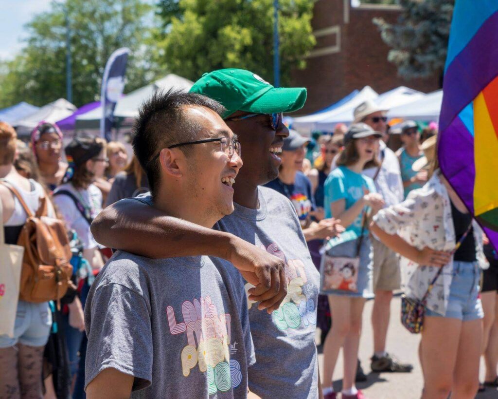 Two men embrace at a Pride event