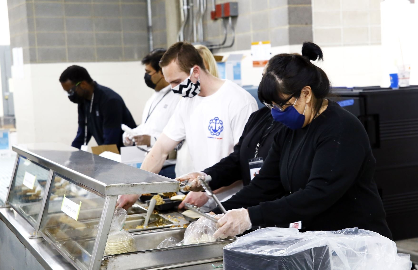 Volunteers serve food at Denver Rescue Mission