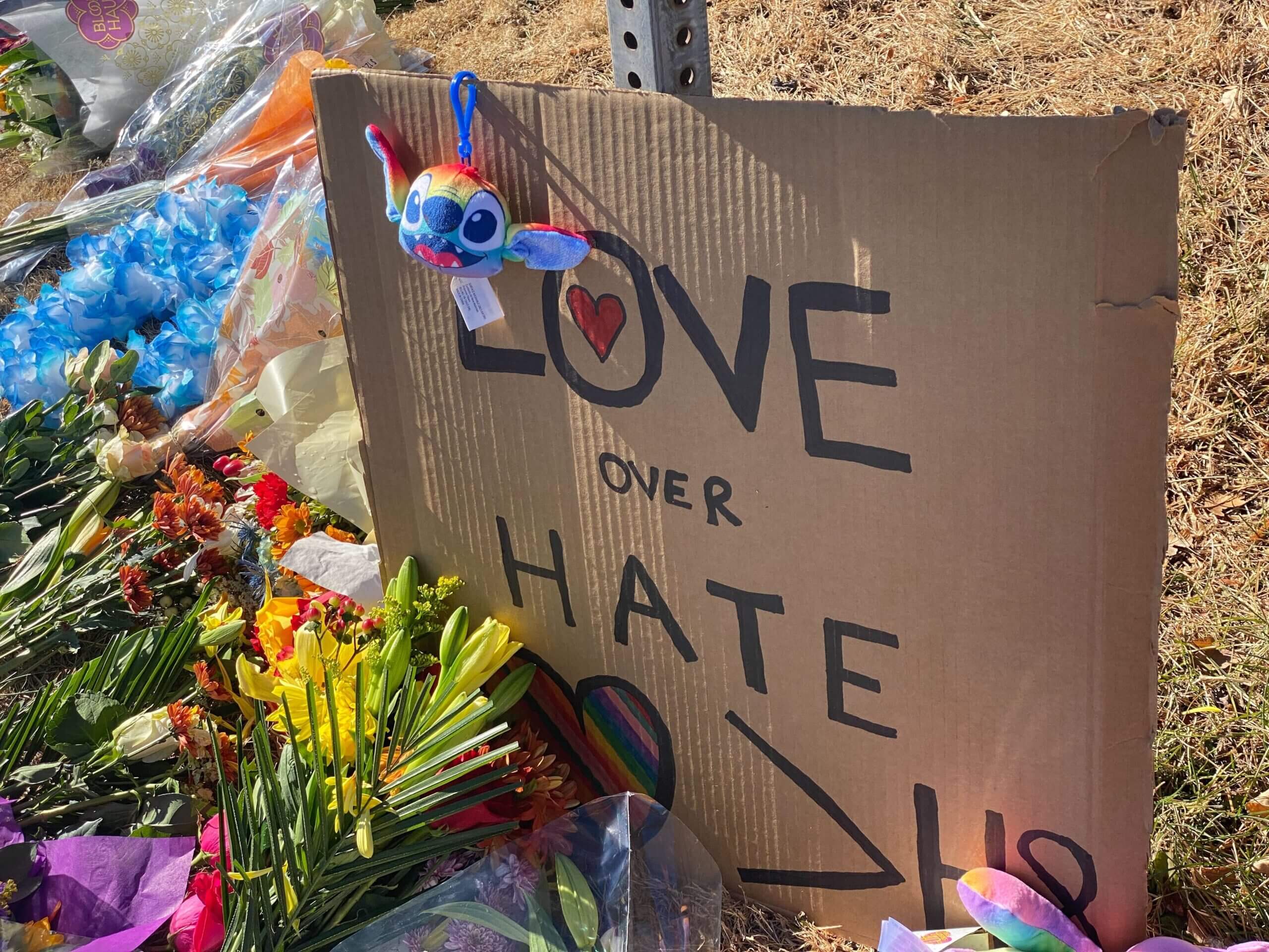 An image of a sign reading LOVE over HATE outside of Club Q in Colorado Springs