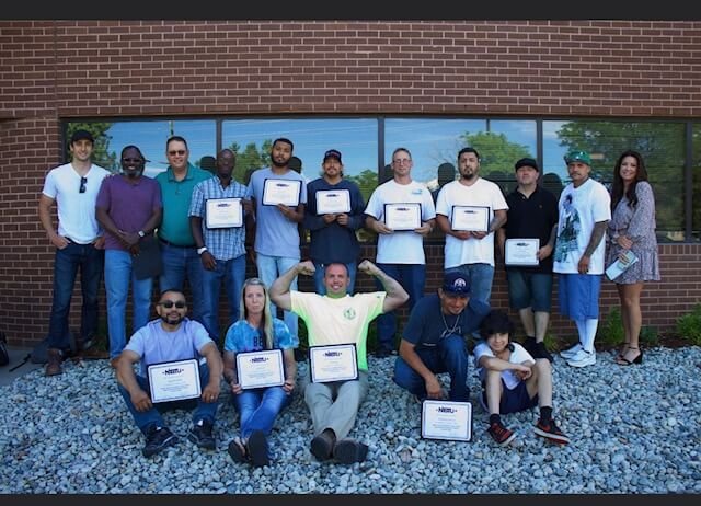 Students pose with diplomas at the Second Chance Center